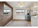 Dining area with brick wall, stainless steel refrigerator, and bright natural light at 4655 Independence St # 3, Wheat Ridge, CO 80033