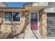 Close up of the front door with brick facade and landscaping details at 4655 Independence St # 3, Wheat Ridge, CO 80033
