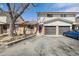 Charming townhome featuring a two-car garage, brick accents, and well-maintained landscaping at 4655 Independence St # 3, Wheat Ridge, CO 80033