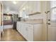 Bright kitchen with white cabinets, stainless steel refrigerator, and view into the living room beyond at 4655 Independence St # 3, Wheat Ridge, CO 80033