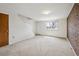 Bright living room area offering neutral carpet and an open staircase at 4655 Independence St # 3, Wheat Ridge, CO 80033