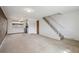 Carpeted living room area with open staircase and direct access to the kitchen at 4655 Independence St # 3, Wheat Ridge, CO 80033