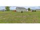 View of the backyard featuring a well-maintained lawn and a detached building at 16516 Fairbanks Rd, Platteville, CO 80651