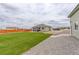 Expansive backyard with a mix of grass, gravel, and patio space, perfect for outdoor enjoyment at 16516 Fairbanks Rd, Platteville, CO 80651
