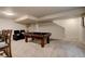 Spacious basement featuring a pool table, a lounge area with reclining chairs, and soft carpet at 16516 Fairbanks Rd, Platteville, CO 80651