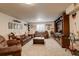 Spacious basement living room area with a large entertainment center and neutral carpeting at 16516 Fairbanks Rd, Platteville, CO 80651