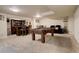 Finished basement with a pool table, a bar area with seating, and a lounge area at 16516 Fairbanks Rd, Platteville, CO 80651