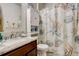 Charming bathroom featuring a vanity with granite counter, a themed shower curtain, and tiled floors at 16516 Fairbanks Rd, Platteville, CO 80651