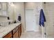 Stylish bathroom featuring granite countertops, a modern vanity, and a glass-enclosed shower with subway tile at 16516 Fairbanks Rd, Platteville, CO 80651