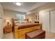 Basement bedroom featuring a wooden bed frame, soft carpet, and neutral decor at 16516 Fairbanks Rd, Platteville, CO 80651