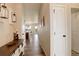Inviting entryway boasts wood floors and stylish decor, leading to a modern open-concept kitchen and dining area at 16516 Fairbanks Rd, Platteville, CO 80651