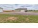 Exterior view showcasing a large garage and driveway with ample parking space at 16516 Fairbanks Rd, Platteville, CO 80651