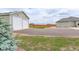 An outdoor view of the large two car detached garage and manicured lawn at 16516 Fairbanks Rd, Platteville, CO 80651