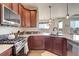 Modern kitchen featuring sleek stainless steel appliances, granite countertops and wood floors at 16516 Fairbanks Rd, Platteville, CO 80651