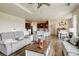 Spacious living room seamlessly connects to the dining area and kitchen, hardwood floors at 16516 Fairbanks Rd, Platteville, CO 80651