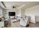Bright living room with tray ceiling, hardwood floors, and comfortable seating at 16516 Fairbanks Rd, Platteville, CO 80651