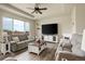 Sun-lit living room with hardwood floors, comfortable seating, and a cozy fireplace at 16516 Fairbanks Rd, Platteville, CO 80651