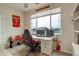 Modern office with a large window overlooking the neighborhood, a gaming chair, and a sports theme at 16516 Fairbanks Rd, Platteville, CO 80651