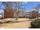 Exterior view of the building with well-maintained lawn and mature tree, creating an inviting atmosphere at 10150 E Virginia Ave # 4-104, Denver, CO 80247