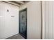 View of secure front door with metal grate and wooden paneling at 10150 E Virginia Ave # 4-104, Denver, CO 80247