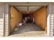 Inside view of an empty attached garage with concrete floor and wood studs at 10150 E Virginia Ave # 4-104, Denver, CO 80247