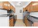 Galley kitchen featuring updated appliances, ample cabinet space, and modern countertops at 10150 E Virginia Ave # 4-104, Denver, CO 80247