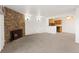 Open-concept living room flows into the kitchen area with a cozy stone fireplace at 10150 E Virginia Ave # 4-104, Denver, CO 80247
