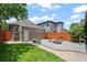 Backyard features paver patio with fire pit and seating, green lawn and privacy fence at 3320 N Columbine St, Denver, CO 80205