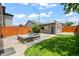 Charming backyard featuring a brick patio with fire pit, privacy fence, and green lawn at 3320 N Columbine St, Denver, CO 80205