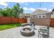 Backyard with stone paver patio featuring a fire pit, outdoor seating, and string lights at 3320 N Columbine St, Denver, CO 80205