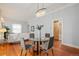 Bright dining area with a glass table and hardwood floors, next to a sliding barn door at 3320 N Columbine St, Denver, CO 80205