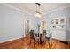 Dining room with hardwood floors, modern chandelier, and a built-in hutch at 3320 N Columbine St, Denver, CO 80205