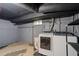 Basement laundry room features modern washer and dryer with plenty of storage at 3320 N Columbine St, Denver, CO 80205