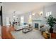 Open-concept living room with hardwood floors, fireplace, and comfortable furniture at 3320 N Columbine St, Denver, CO 80205