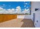 Private backyard with gravel groundcover and secure white fencing at 5147 N Waco St, Denver, CO 80249