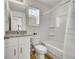 Bright bathroom with a granite vanity top, bathtub, and white fixtures at 5147 N Waco St, Denver, CO 80249