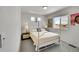 Bright bedroom featuring a white metal bed frame, plush bedding, and ample natural light from a window at 5147 N Waco St, Denver, CO 80249