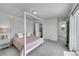 Comfortable bedroom with a four-poster bed and access to the bathroom at 5147 N Waco St, Denver, CO 80249