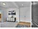 Bright entryway features wood flooring, a stylish cabinet, modern art, and a front door at 5147 N Waco St, Denver, CO 80249