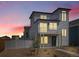 Charming two-story home with modern design, balcony, landscaped front yard, and a vibrant sunset at 5147 N Waco St, Denver, CO 80249
