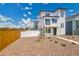 Striking two-story home with modern design, including dual balconies and low maintenance gravel front yard at 5147 N Waco St, Denver, CO 80249