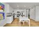 Bright, modern kitchen with stainless steel appliances, sleek white cabinets, and hardwood floors at 5147 N Waco St, Denver, CO 80249