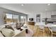 Bright and airy living room with large windows, modern furniture, and hardwood floors at 5147 N Waco St, Denver, CO 80249