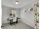 Small office with a dark wood desk, carpeted floors, and a patterned bookshelf at 5147 N Waco St, Denver, CO 80249