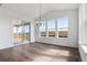Dining area with large windows, sliding glass door, and modern chandelier at 25214 E Warren Pl, Aurora, CO 80018