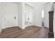 Inviting entryway with beautiful wood-look floors and a view of a bright powder room at 25214 E Warren Pl, Aurora, CO 80018