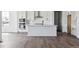 Modern kitchen with white cabinets, stainless steel appliances, and a spacious center island at 25214 E Warren Pl, Aurora, CO 80018