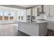 Bright modern kitchen featuring stainless steel appliances, a large island, and open sight lines at 25214 E Warren Pl, Aurora, CO 80018