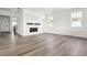 Spacious living room with hardwood floors, modern fireplace, and bright natural light at 25214 E Warren Pl, Aurora, CO 80018