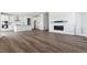 Open-concept living area with hardwood floors, fireplace, and a modern kitchen with stainless steel appliances at 25214 E Warren Pl, Aurora, CO 80018